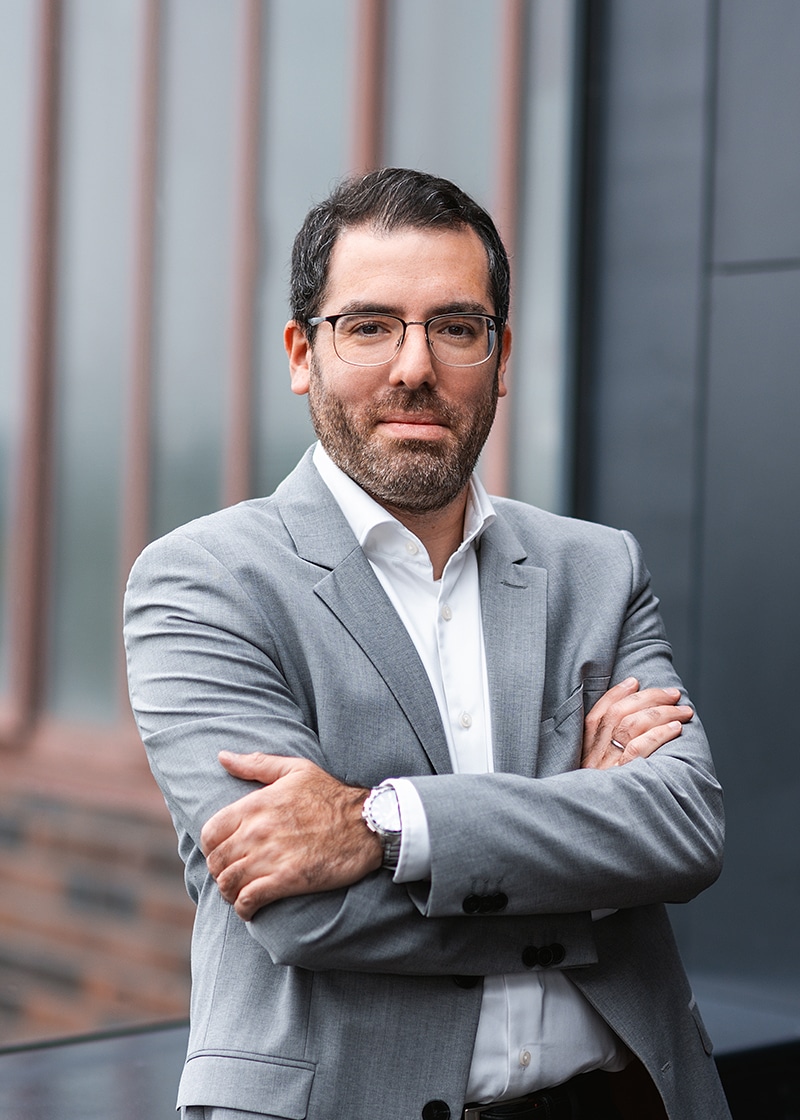 Business professional in a suit, representing eMobility and the future of mobility.