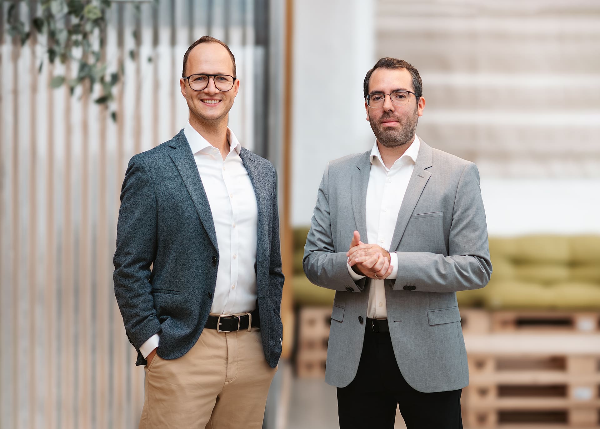 Two professionals discussing eMobility solutions in a modern office setting, representing the future of mobility.