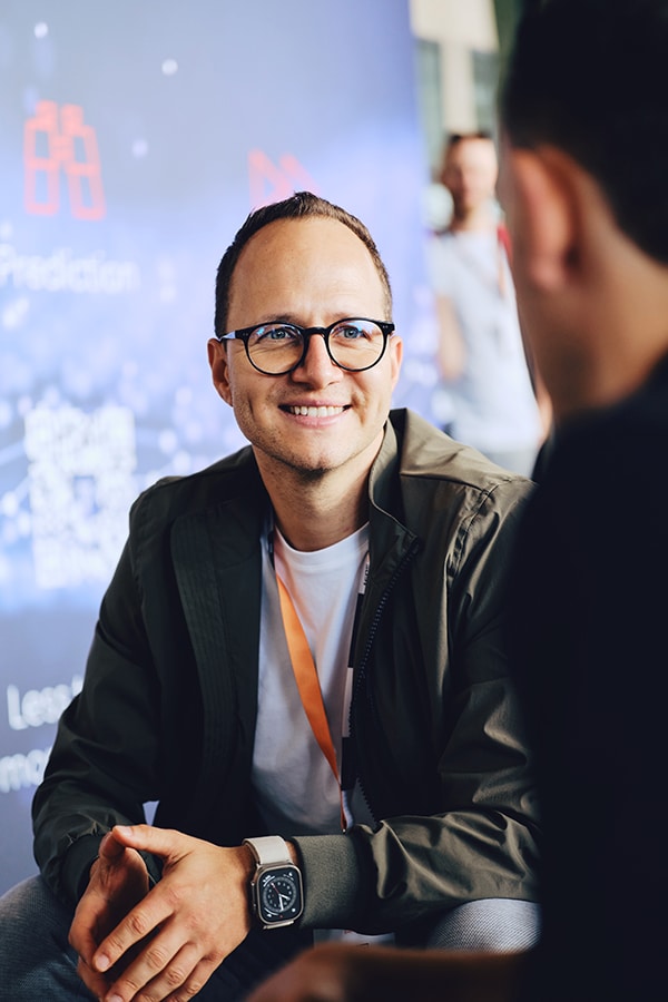 Person engaging in discussion at eMobility event, showcasing future of mobility advancements.