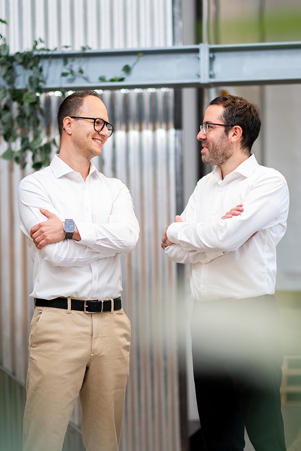 Two professionals discussing eMobility solutions in a modern office environment.