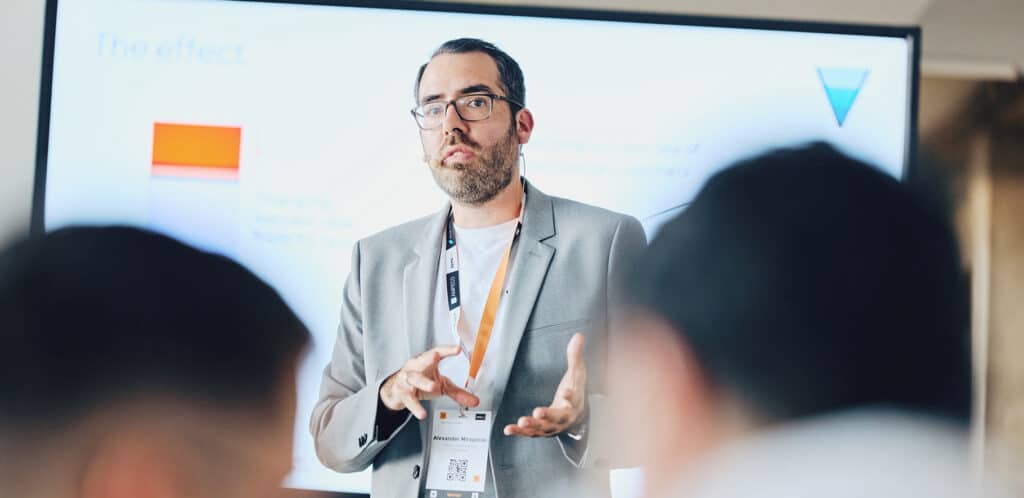 Speaker discussing eMobility solutions at a conference, highlighting the future of mobility advancements.