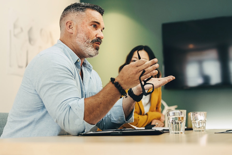 A person discusses eMobility trends in a modern meeting room, emphasizing the future of mobility.