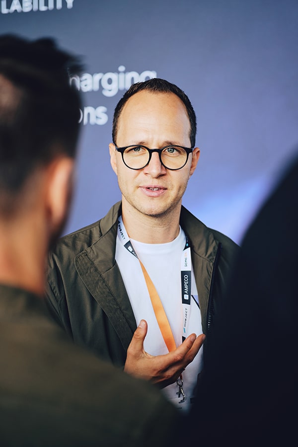 Person discussing EV-Charging at an eMobility event, focusing on the future of mobility innovations.