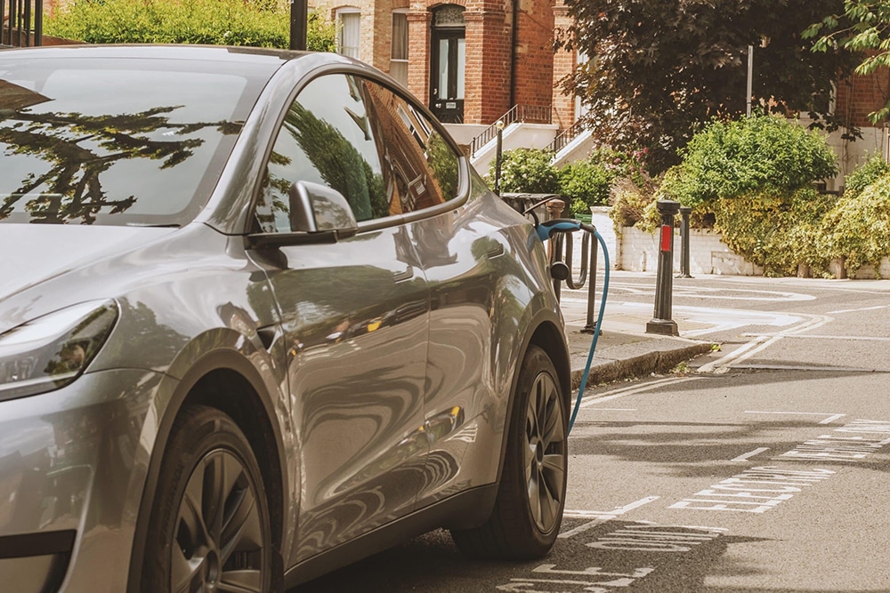 Electric car charging on street, showcasing EV-Charging as the future of mobility.
